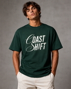 Men’s forest green 240 GSM cotton regular fit graphic T-shirt with Coast Shift front typography by ZVYRO