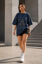 woman wearing navy blue acid-wash oversized graphic T-shirt with black denim shorts